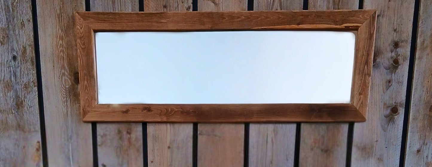 Rustic reclaimed wood 'Boëme' mirror made from solid oak, staged against a black accent wall with vertical scaffolding planks.