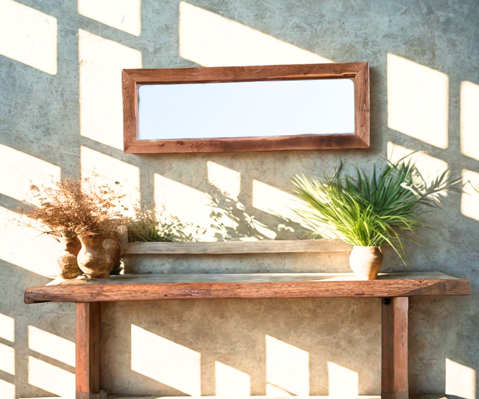 Rustic reclaimed wood ‘Boëme’ mirror styled in a conceptual lifestyle design, set against a micro cement accent wall with a minimal wooden shelf. Paired with the ‘Charente’ reclaimed oak console table — once a carpenter’s workbench, now reimagined with distinctive teak bow tie joins.
