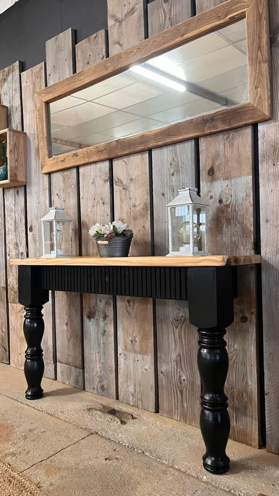 Side view of black upcycled pine console table showing fluted oak detailing and curved farmhouse-style legs, handmade in France. Also featuring Boëme XL solid oak mirror.