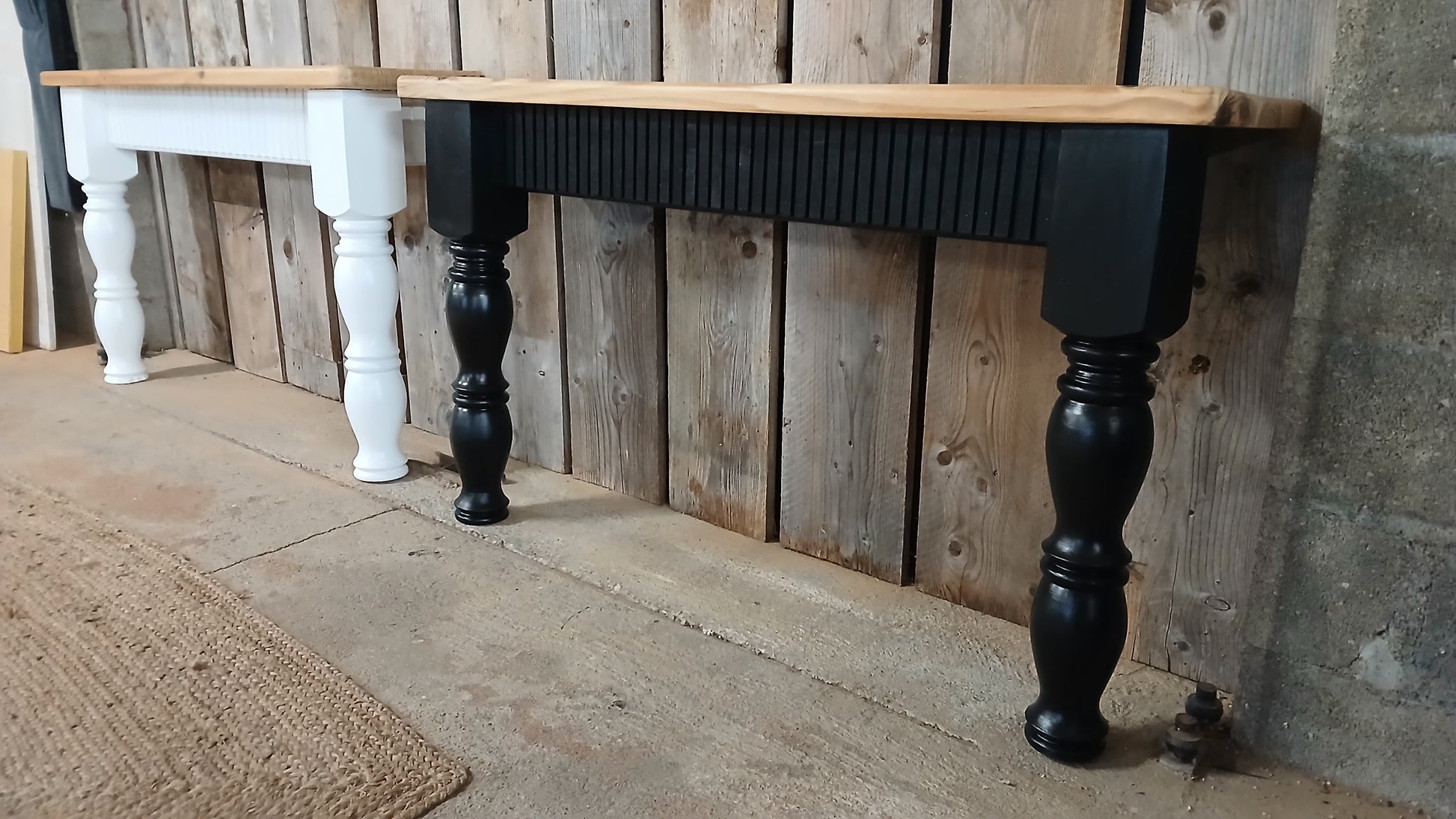 Side view of black and white upcycled pine console tables showing fluted oak detailing and curved farmhouse-style legs, handmade in France