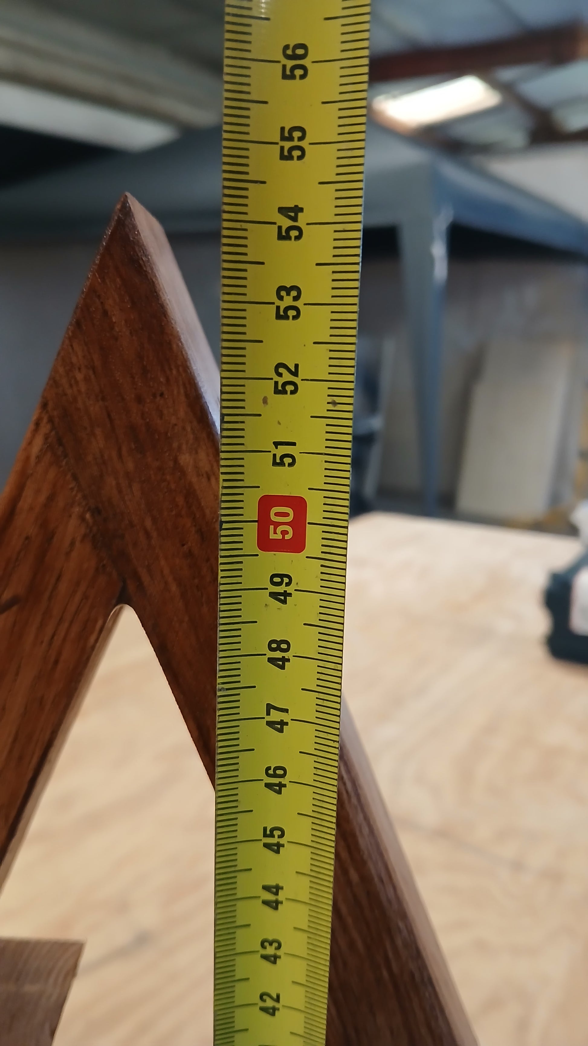 Photo showing the height of our chestnut Christmas tree from our festive decoration collection in the workshop, measuring : 54cm. 