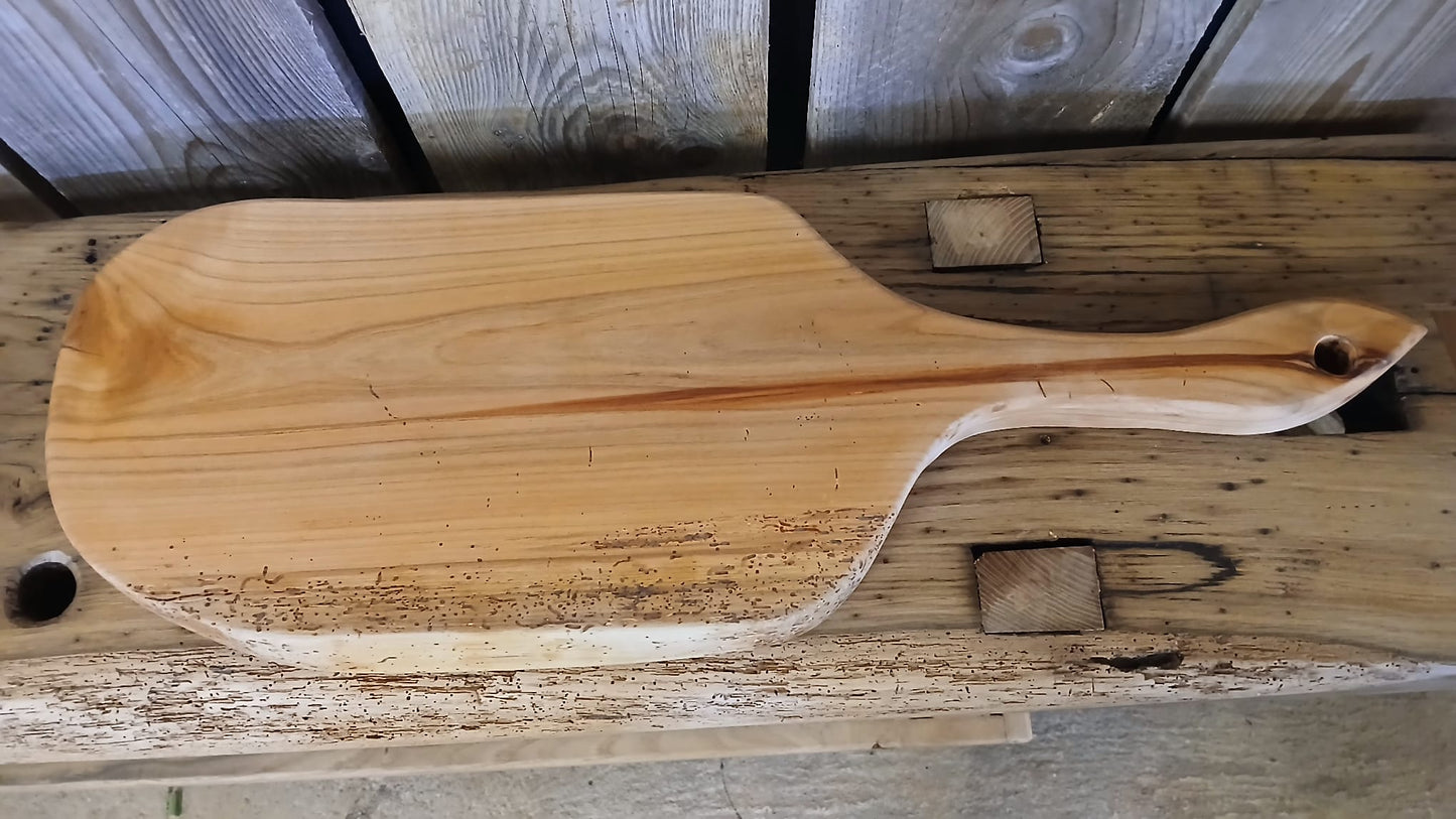 Birds eye view of wide style of French cherry wood serving board, highlighting natural grain, handmade in France.