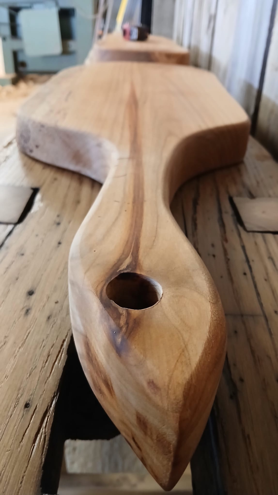 Close up view of French cherry wood charcuterie board or cheese board, showcasing natural grain and handcrafted detail, handmade in France.