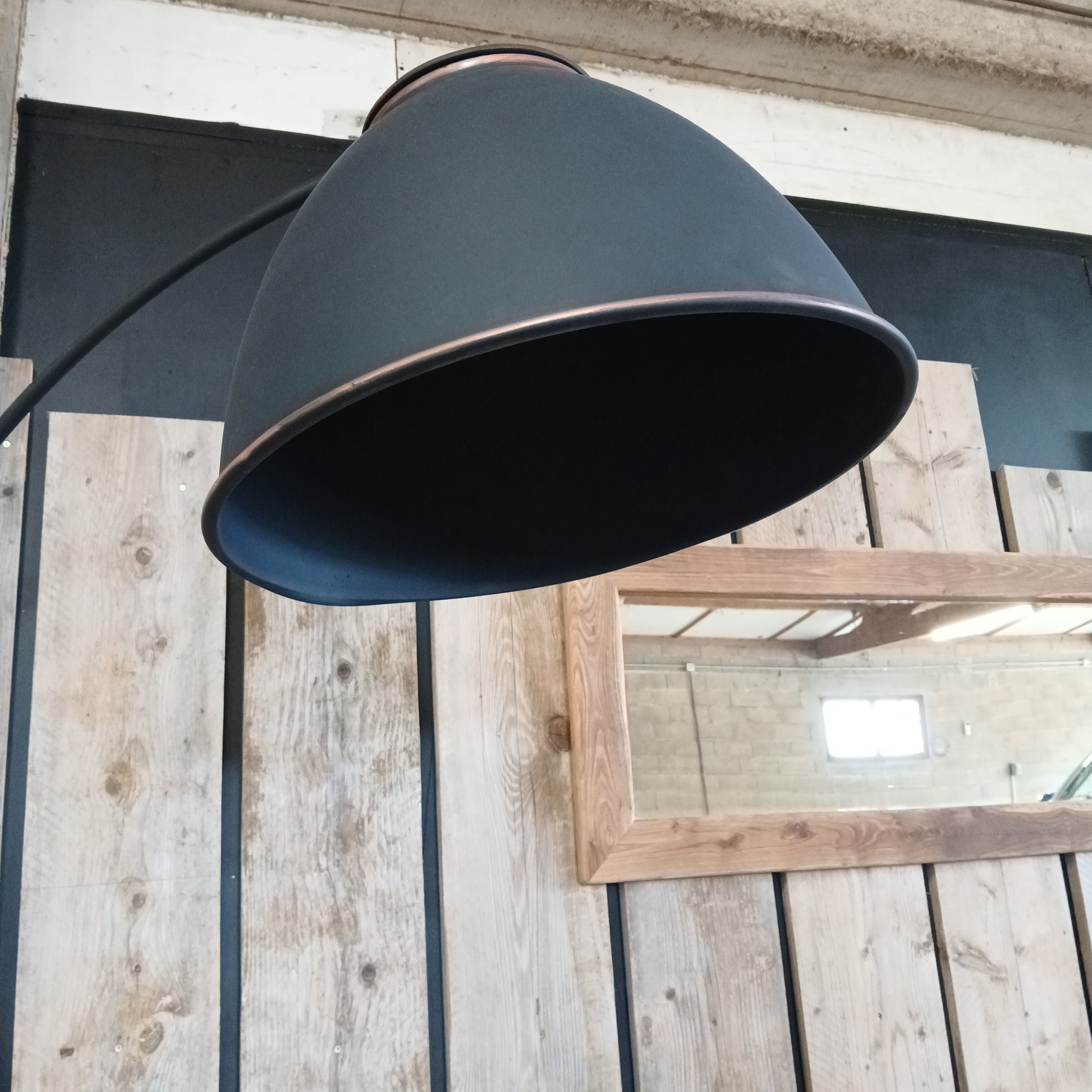 Angoulême industrial floor lamp with reclaimed aluminium shade in copper and satin black, styled with Boëme XL rustic oak mirror and scaffolding planks, handmade in France.